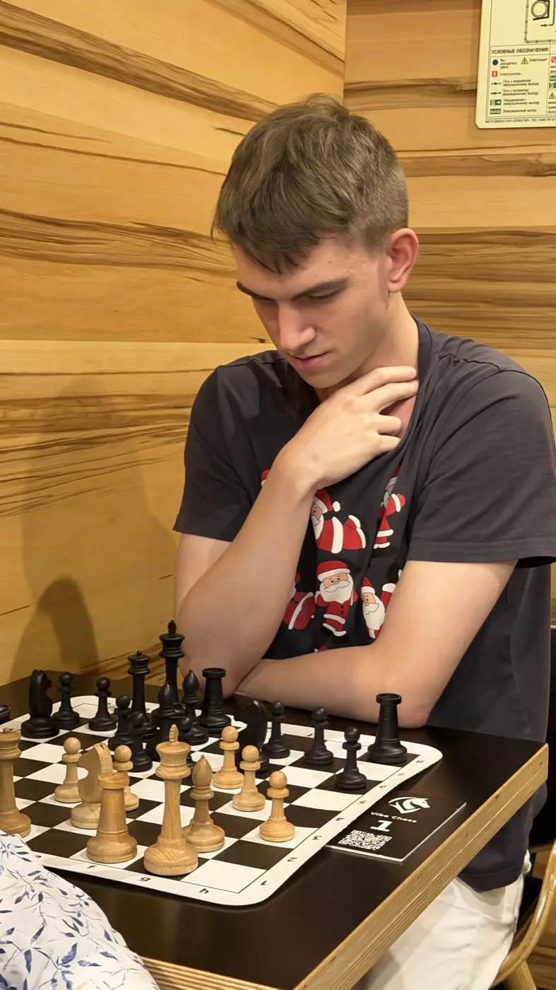 A player thinking over the position, hand at his chin