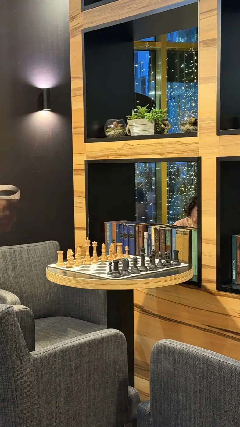 A round table with a board against a shelf of books
