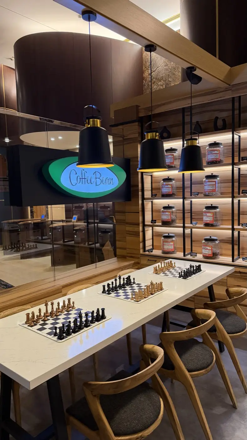 A table with three sets of pieces set up in the coffee shop hall