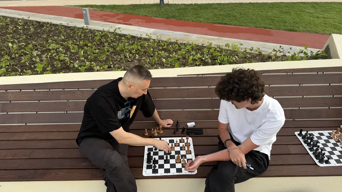 Two people playing a calm game of chess on the embankment