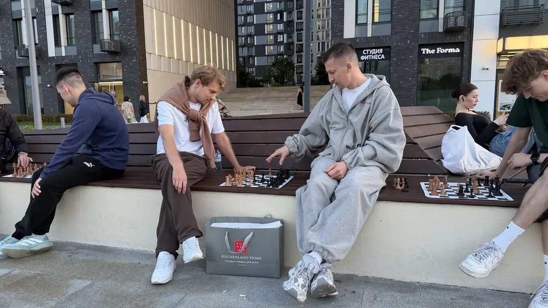 People meeting over chess on an evening walk