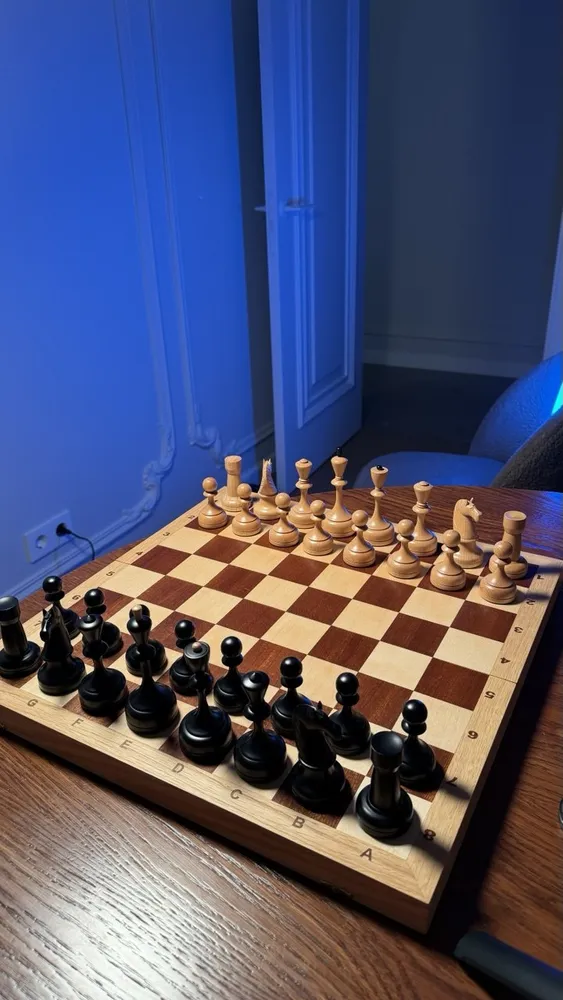 A chessboard with the pieces set up - side view, both sets