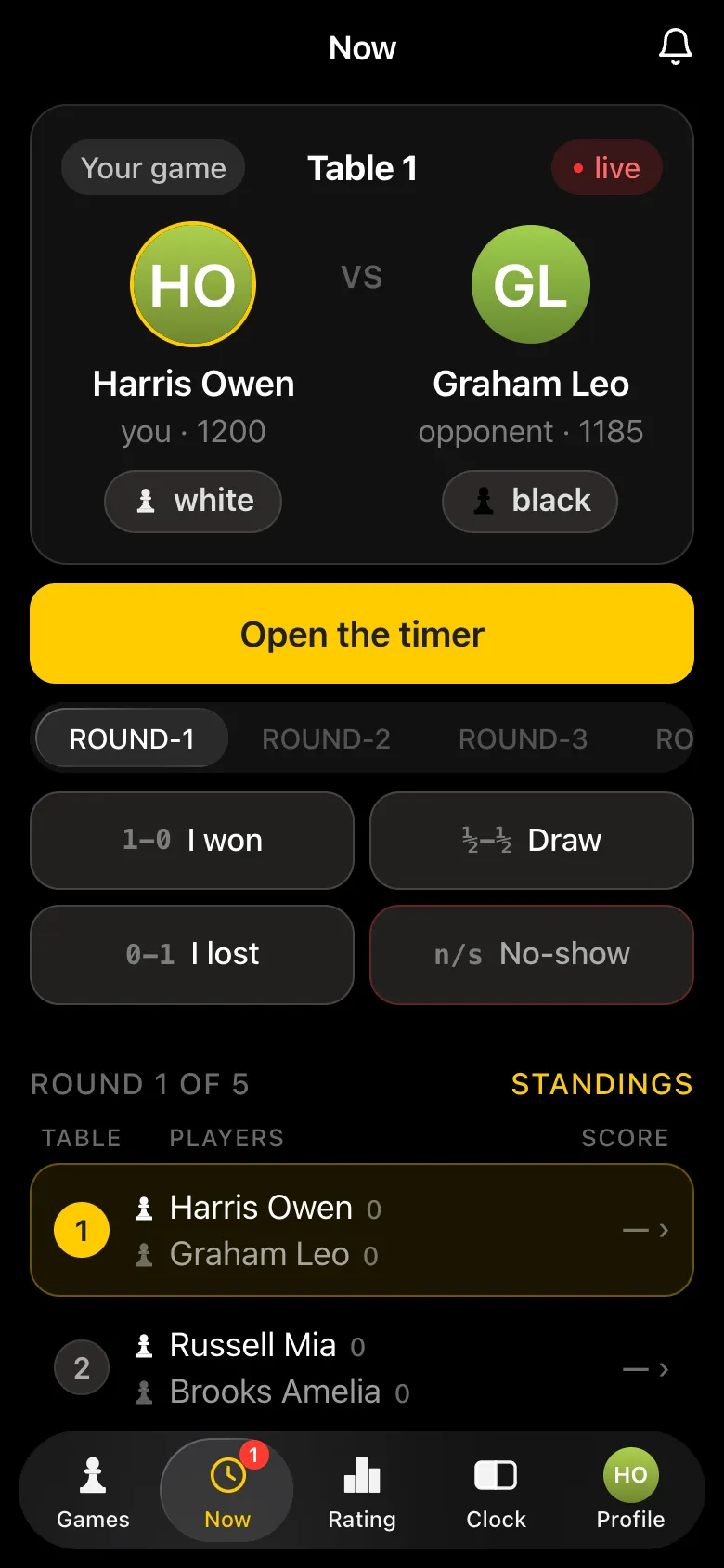 Round 1 of 5 of the round robin: organiser Harris Owen plays at table 1 against Graham Leo, everyone has a screen with a timer and result buttons